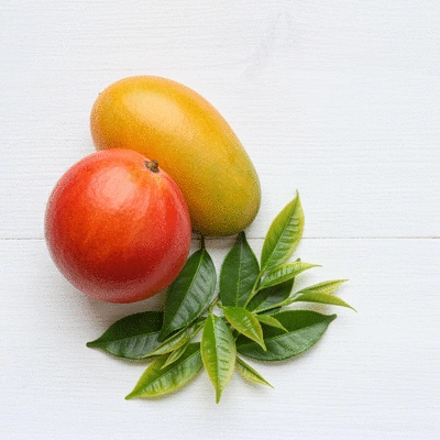 African mango fruit and green tea leaves arranged aesthetically
