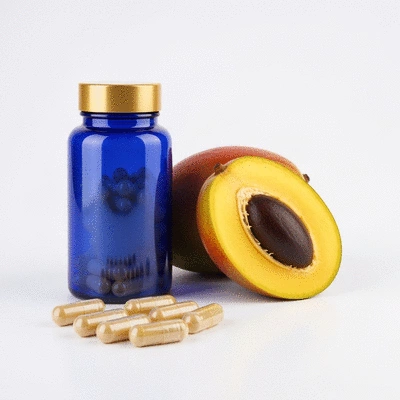 African mango extract capsules and fresh African mango fruit on a clean background